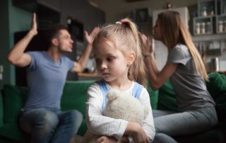 Domestic Violence Help in Queensland, Australia. Accompanying picture: A girl feels upset while parents fighting at background