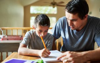 COVID, Courts and Contravention. Accompanying image: father helping son with homework on table at home