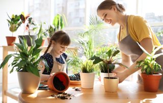 Dealing with stress. Accompanying picture: mother and daughter taking care of home plants at table indoors