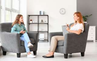 Image of a Psychologist working with teenage girl in office, accompanying article "Sharing information from your child’s psychologist in court"