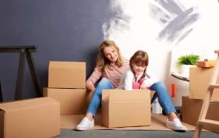 Image of mother and daughter packing boxes, accompanying family law article "Relocating after divorce – can I take my child with me?"