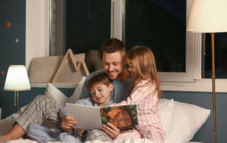 Image of father and two children accompanying family law article "Can a tightly-held belief derail your parenting?"