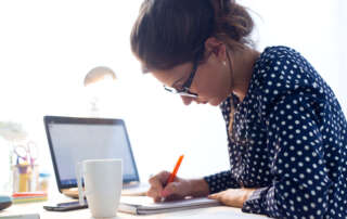 Image of a young woman working in her office.
