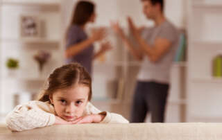 Image of parents arguing while child is upset